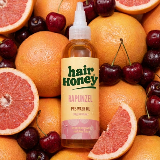 Close-up of Rapunzel Pre-Wash Hair Oil for Growth Boost highlighting the bottle and its rich texture.