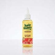 Hair Syrup Watermelon Oil - Pre-Wash Treatment for Dry Hair in a stylish bottle on a wooden surface.