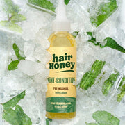 Mint Condition Scalp Oil for Flaky, Itchy Scalp Relief with a plant background emphasizing its natural ingredients.