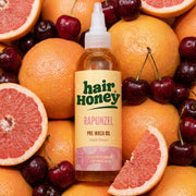 Close-up of Rapunzel Pre-Wash Hair Oil for Growth Boost highlighting the bottle and its rich texture.