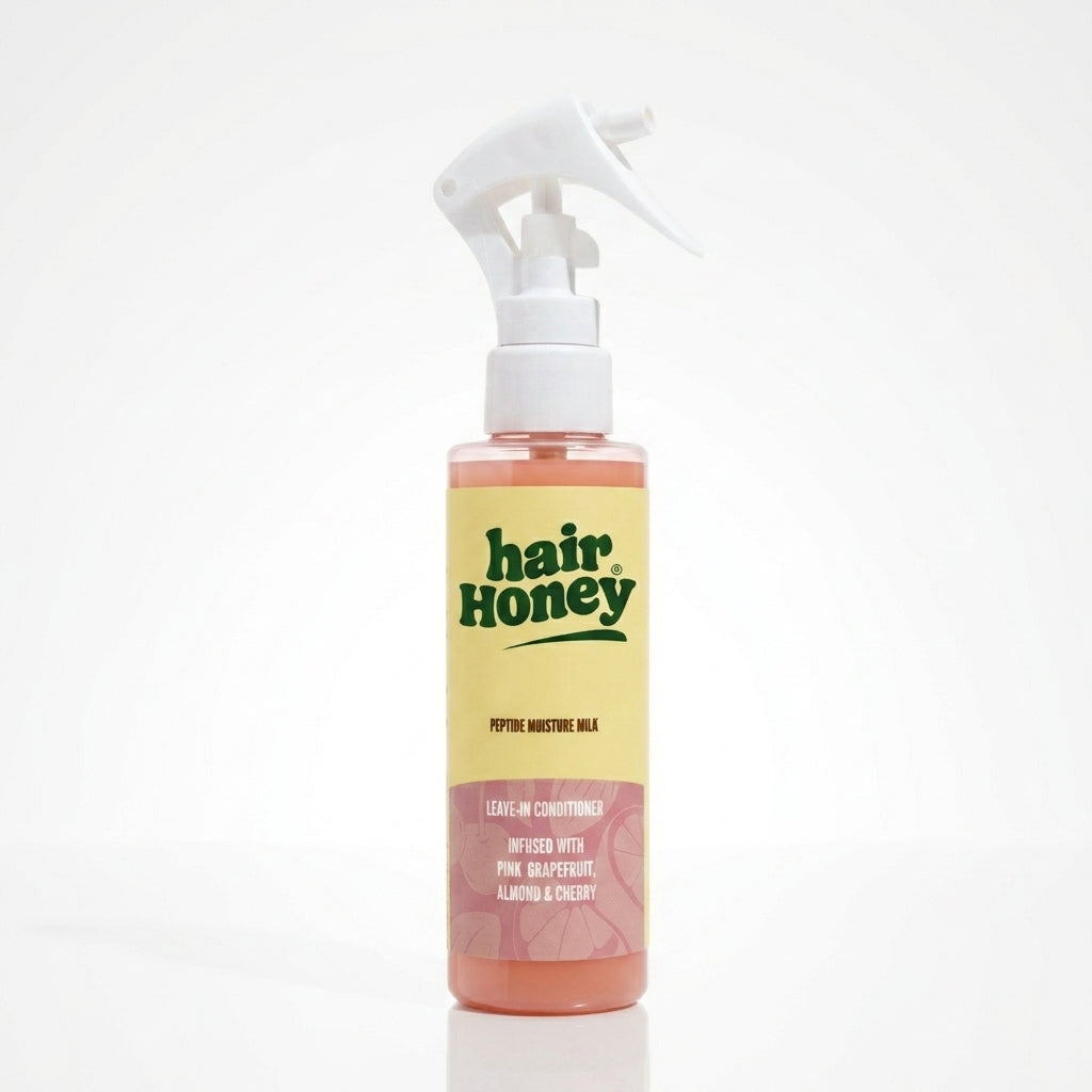 Hair Syrup Rapunzel Leave-In Conditioner Spray 100ml bottle on a wooden surface.