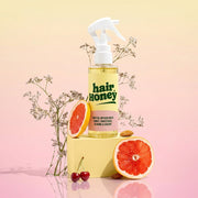 Hair Syrup Rapunzel Leave-In Conditioner Spray 100ml next to hair care accessories.