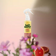 Hair Syrup Rapunzel Leave-In Conditioner Spray 100ml in a bright, airy setting.