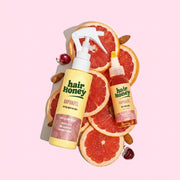 Hair Syrup Rapunzel Leave-In Conditioner Spray 100ml displayed with fresh herbs.