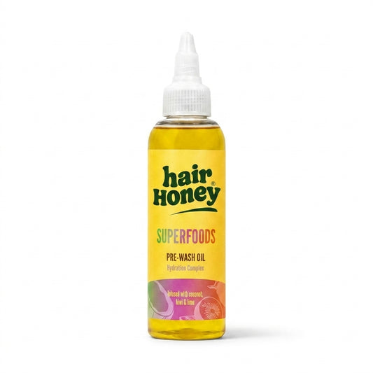 Superfoods Pre-Wash Treatment for Dry, Thirsty Hair in a stylish bottle on a wooden surface.