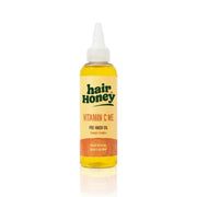 Vitamin C Pre-Wash Treatment for Damaged, Brittle Hair in a stylish bottle on a wooden surface.