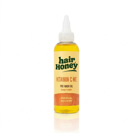 Vitamin C Pre-Wash Treatment for Damaged, Brittle Hair in a stylish bottle on a wooden surface.