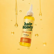 Application of Vitamin C Pre-Wash Treatment for Damaged, Brittle Hair on hair strands, showcasing its texture.